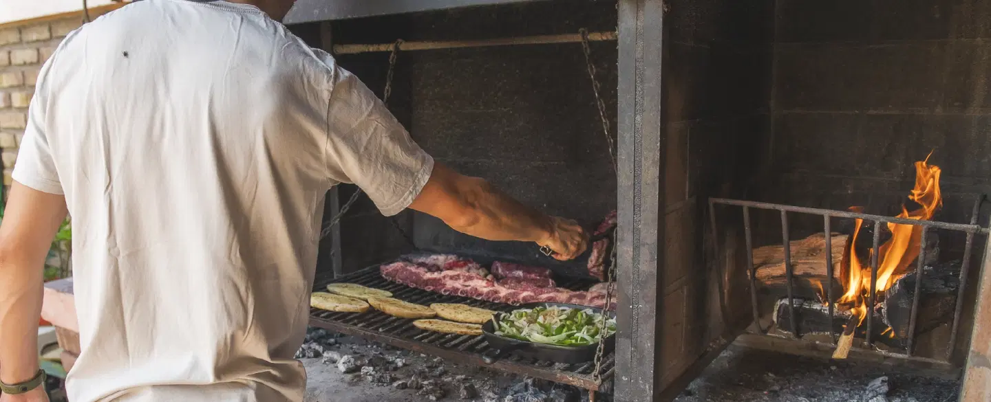 Argentinian Family-style Asado in a local home in Mendoza with food shopping, grilling, and wine.