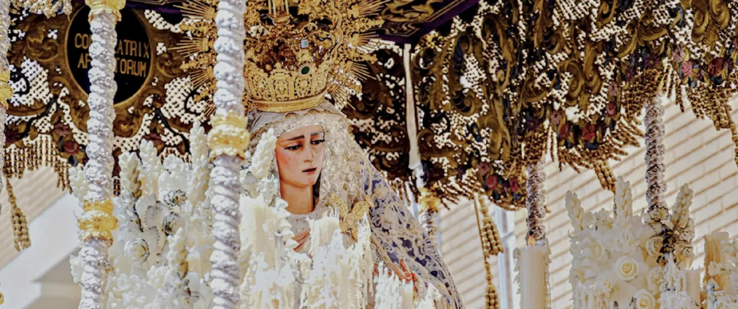 Semana Santa Holy Week Walking Tour in Seville following street-level processions, nazarenos, pasos.