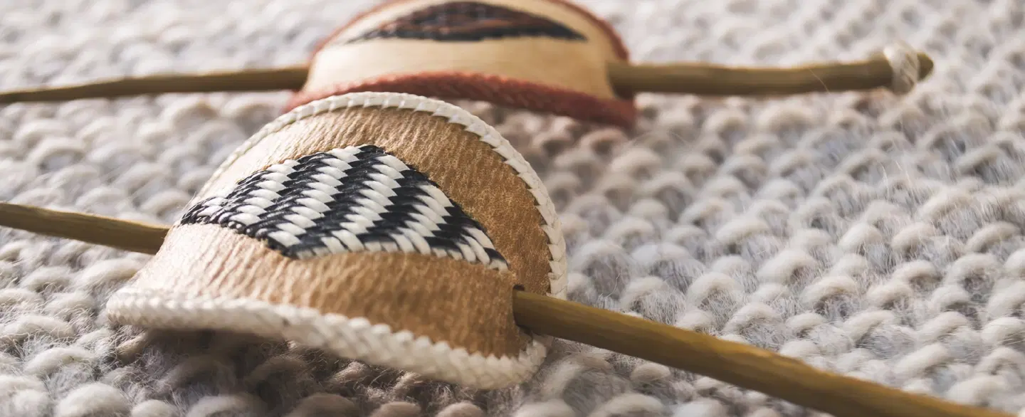 Cultural Walking & Shopping Tour in Mendoza artisan market handling gaucho items & handmade crafts.