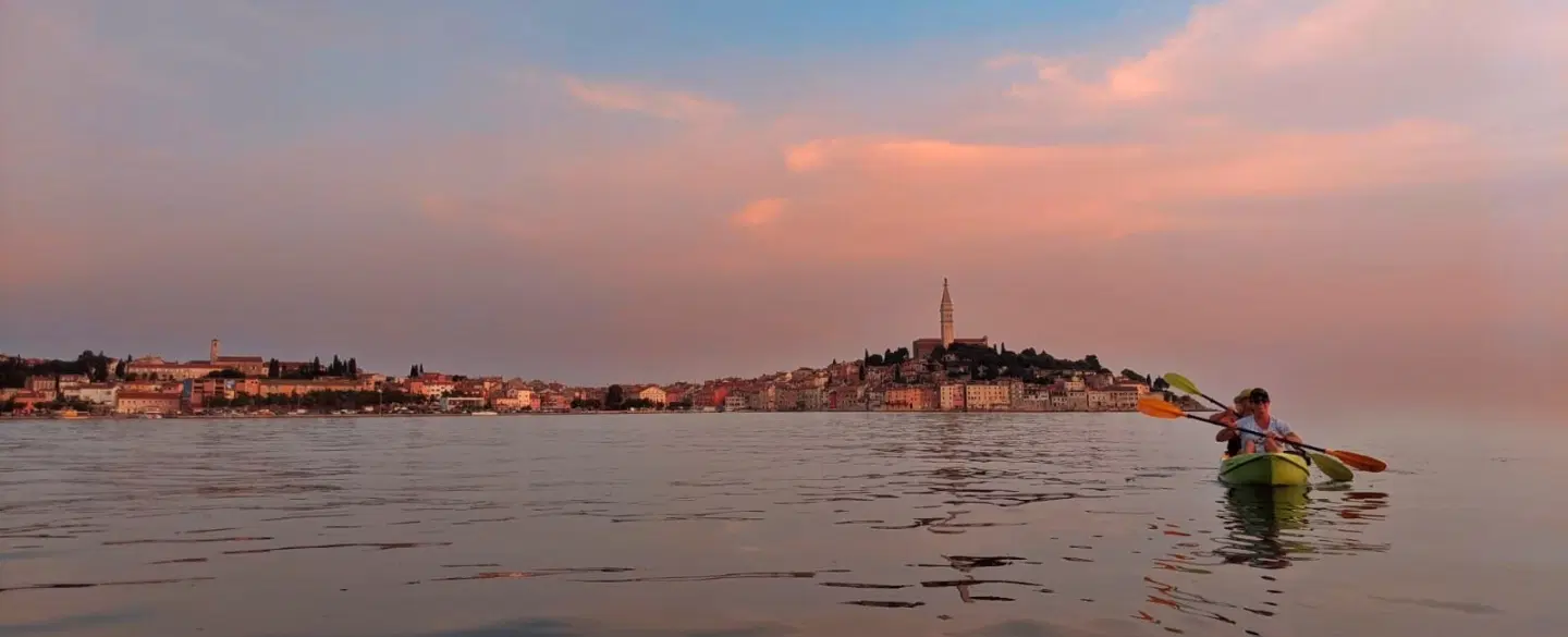 Sunset Kayak Tour from Rovinj, Istria, paddling to an island with swim, snorkel and seaside grill.