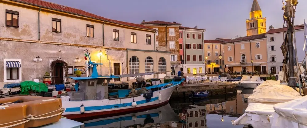 Boat and E-Bike Tour from Trieste to Muggia, exploring historic architecture and a scenic vineyard.