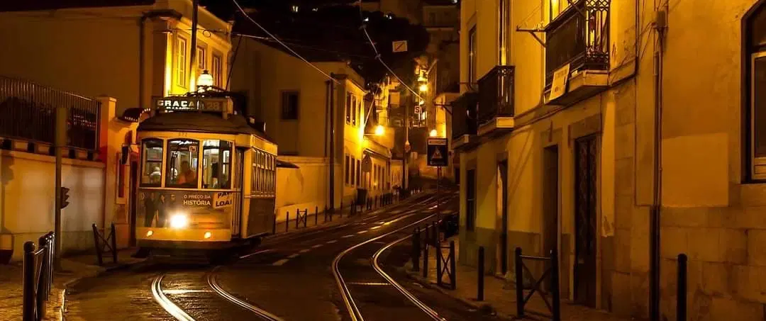 Fado Tour in Lisbon by night with city drive, Alfama walk, and live music in traditional fado house.