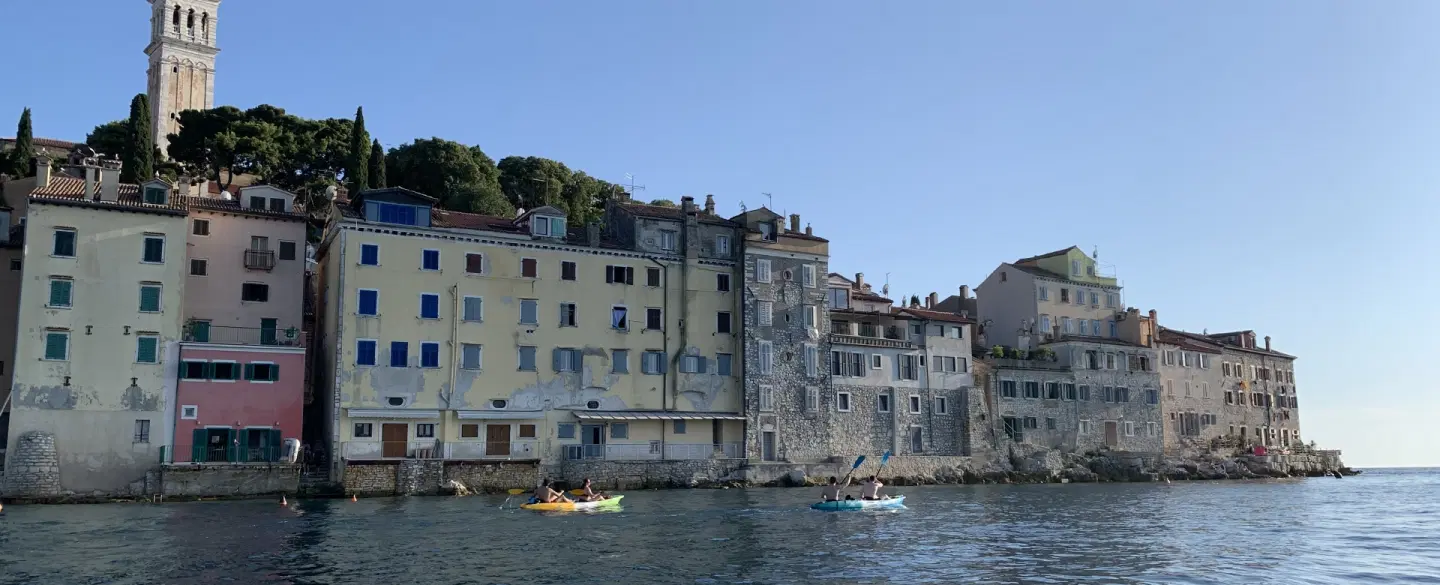 Sunset Kayak Tour from Rovinj, Istria, paddling to an island with swim, snorkel and seaside grill.