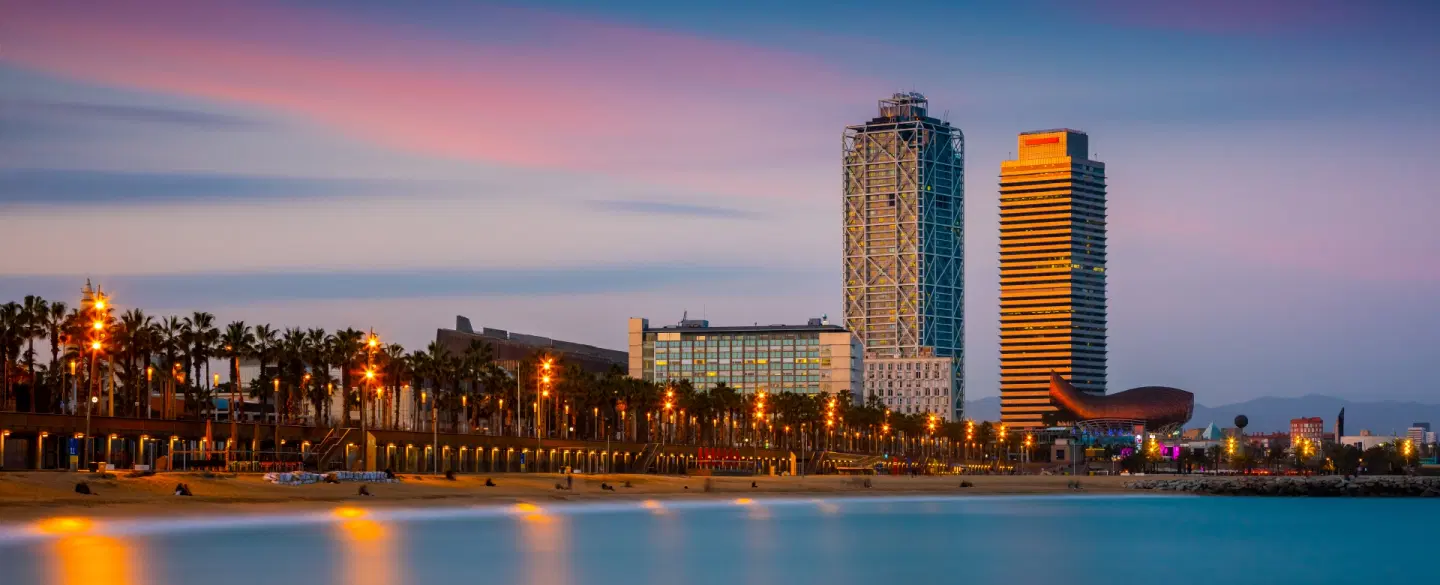 Boat tour on a catamaran at sunset in Barcelona with wine, coastal views, and local stories. 
