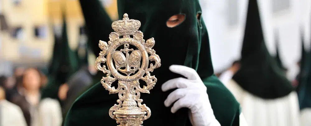 Semana Santa Holy Week Walking Tour in Seville following street-level processions, nazarenos, pasos.