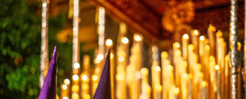 Semana Santa Holy Week Walking Tour in Seville following street-level processions, nazarenos, pasos.
