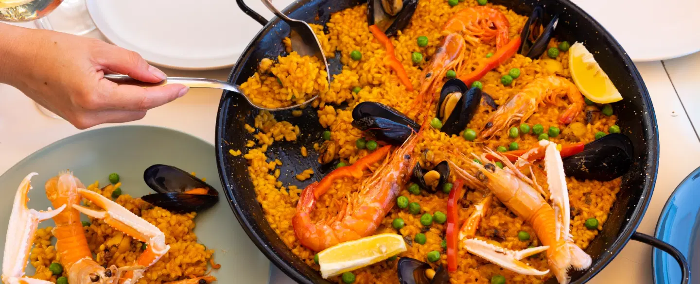 Boat Tour in Barcelona in a luxury catamaran, cook paella onboard, and share a long Catalan lunch.