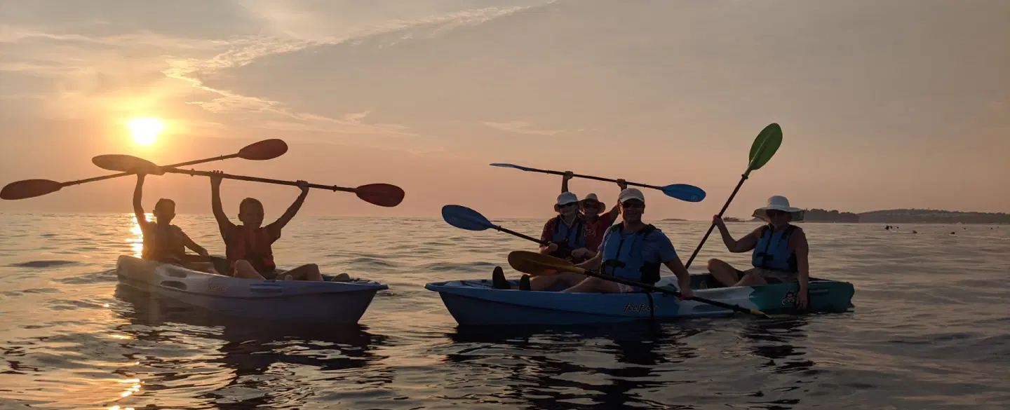 Sunset Kayak Tour from Rovinj, Istria, paddling to an island with swim, snorkel and seaside grill.