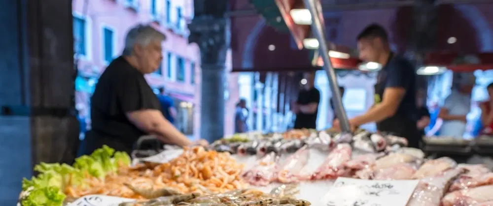 Walking Tour in Venice at sunrise through Piazza San Marco, quiet calli, and Rialto Market.