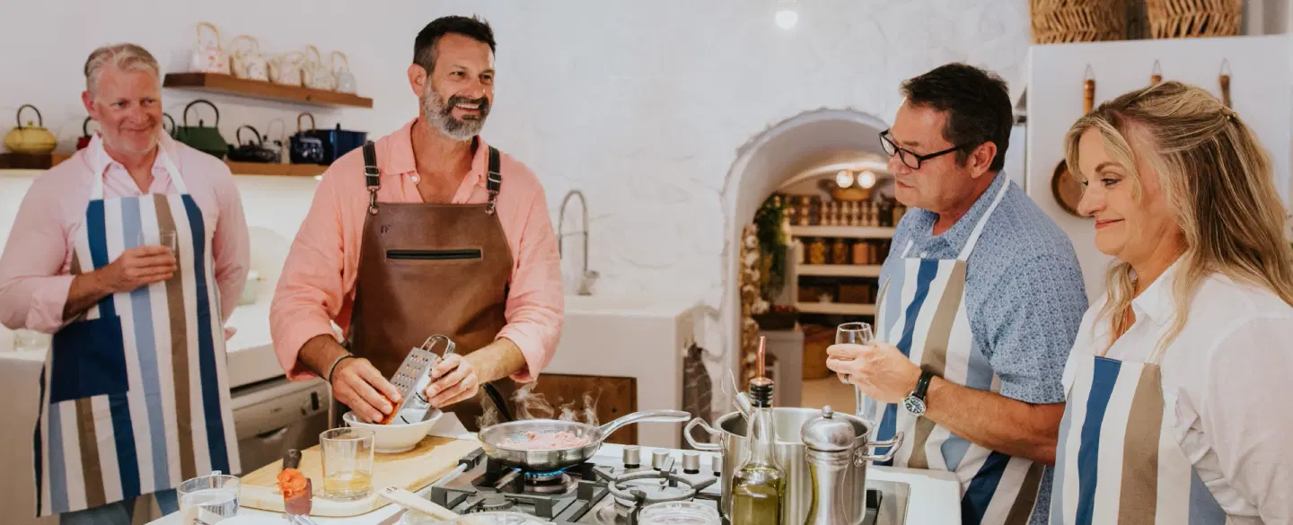Cooking Class set in a cave kitchen in Santorini, preparing Greek dishes and dining together.