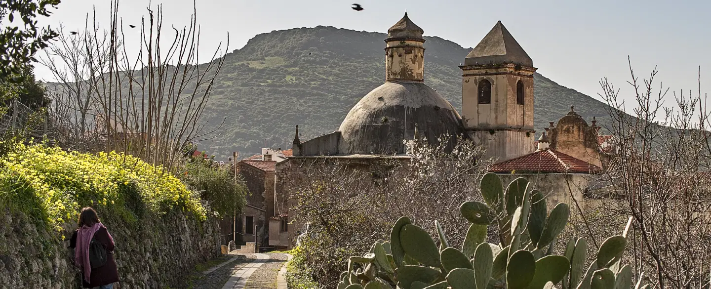 Photo Walk to explore a fascinating village in Sardinia and capture its colored houses at sunset.