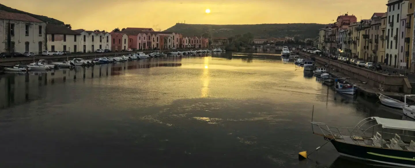 Photo Walk to explore a fascinating village in Sardinia and capture its colored houses at sunset.