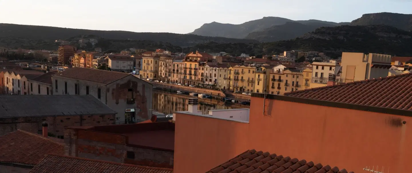Photo Walk to explore a fascinating village in Sardinia and capture its colored houses at sunset.