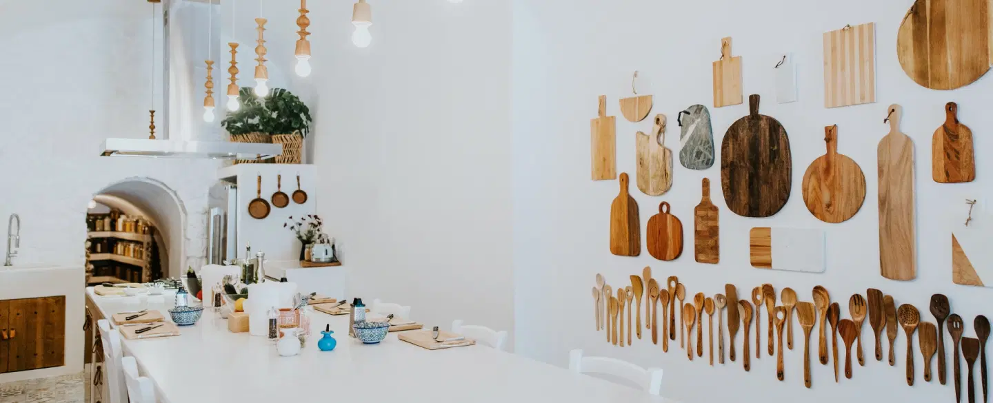 Cooking Class set in a cave kitchen in Santorini, preparing Greek dishes and dining together.