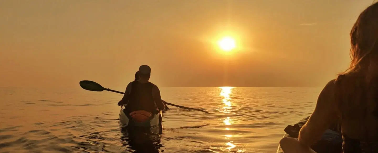 Sunset Kayak Tour from Rovinj, Istria, paddling to an island with swim, snorkel and seaside grill.