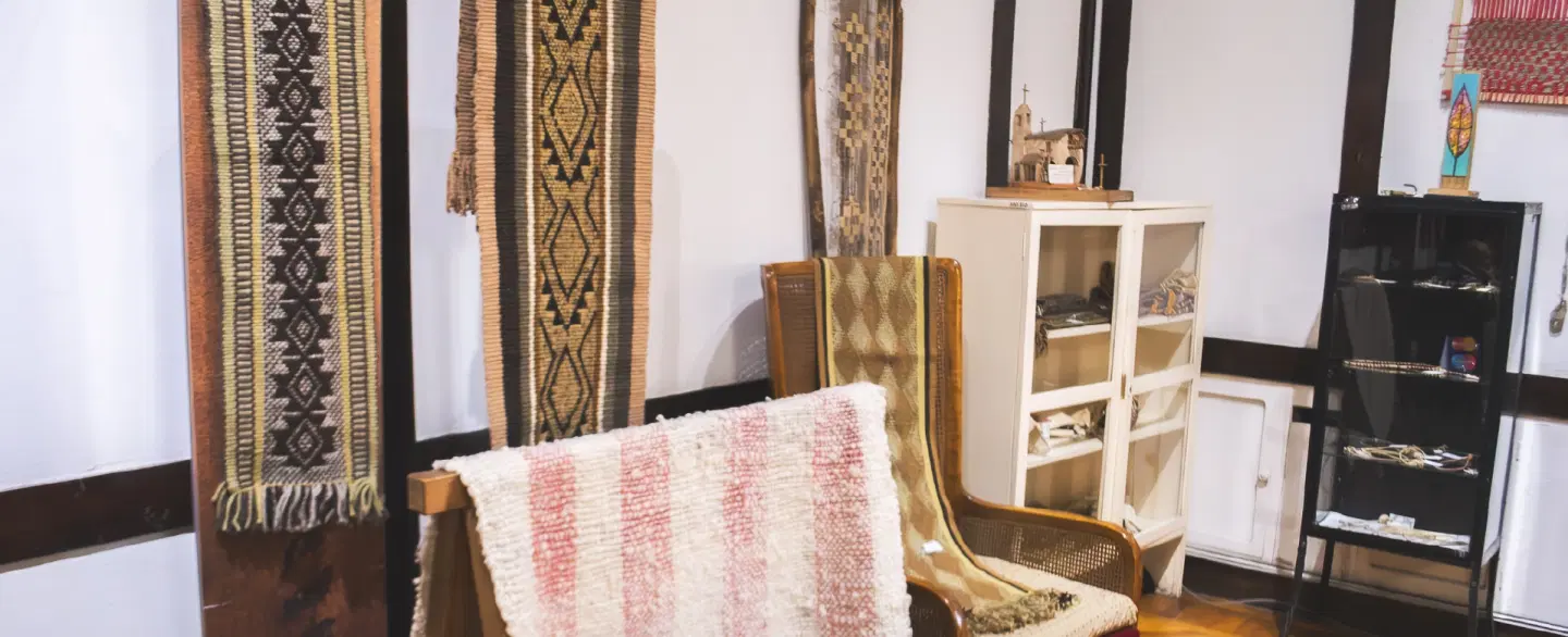 Cultural Walking & Shopping Tour in Mendoza artisan market handling gaucho items & handmade crafts.