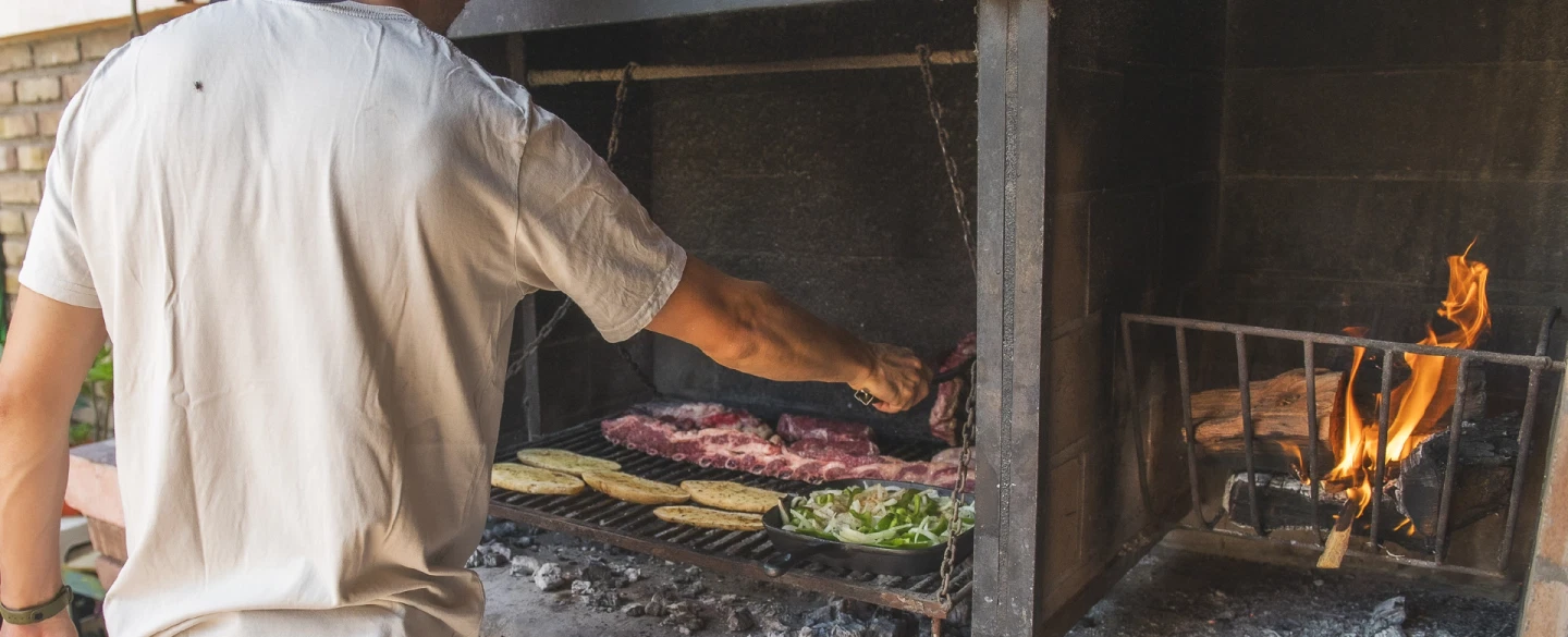 Argentinian Family-style Asado in a local home in Mendoza with food shopping, grilling, and wine.
