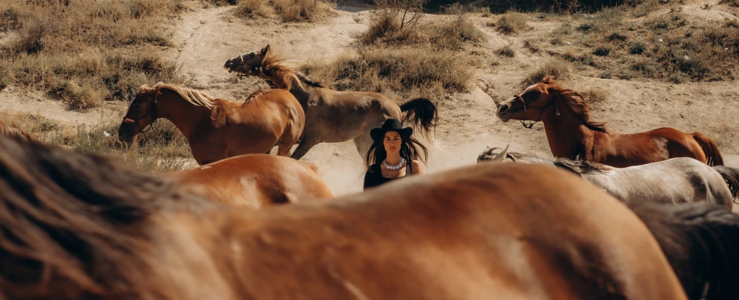 Portrait Photoshoot in Cappadocia with wild horses, dramatic landscapes, and expert photographer.