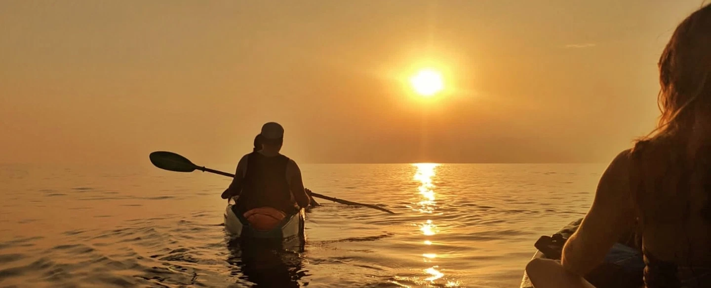 Sunset Kayak Tour from Rovinj, Istria, paddling to an island with swim, snorkel and seaside grill.