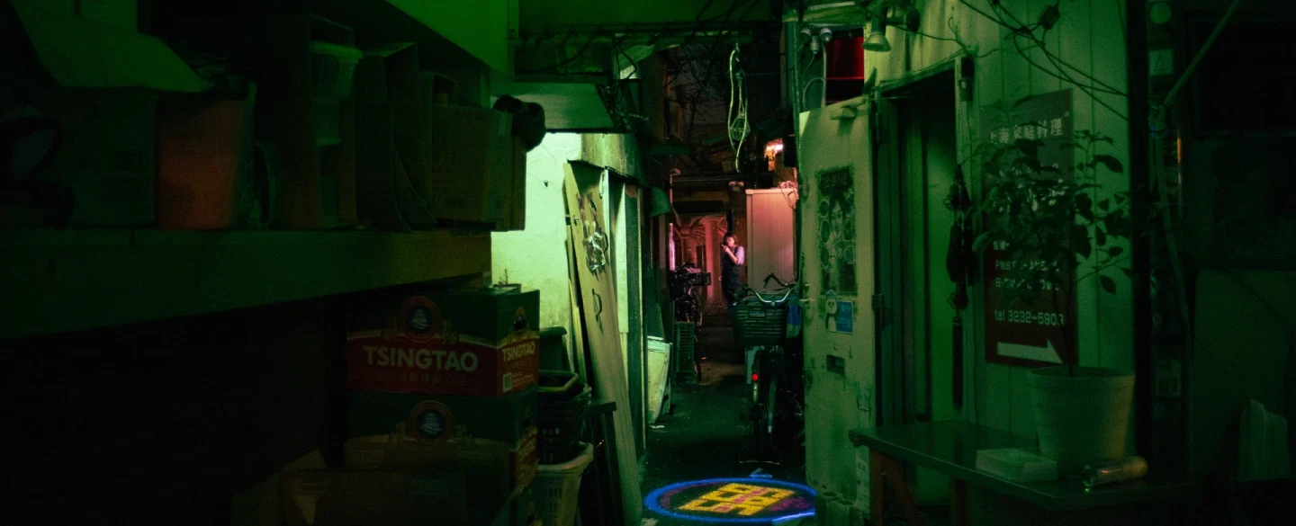 Tokyo night street photography tour in Shinjuku's neon-lit alleys with a documentary photographer.