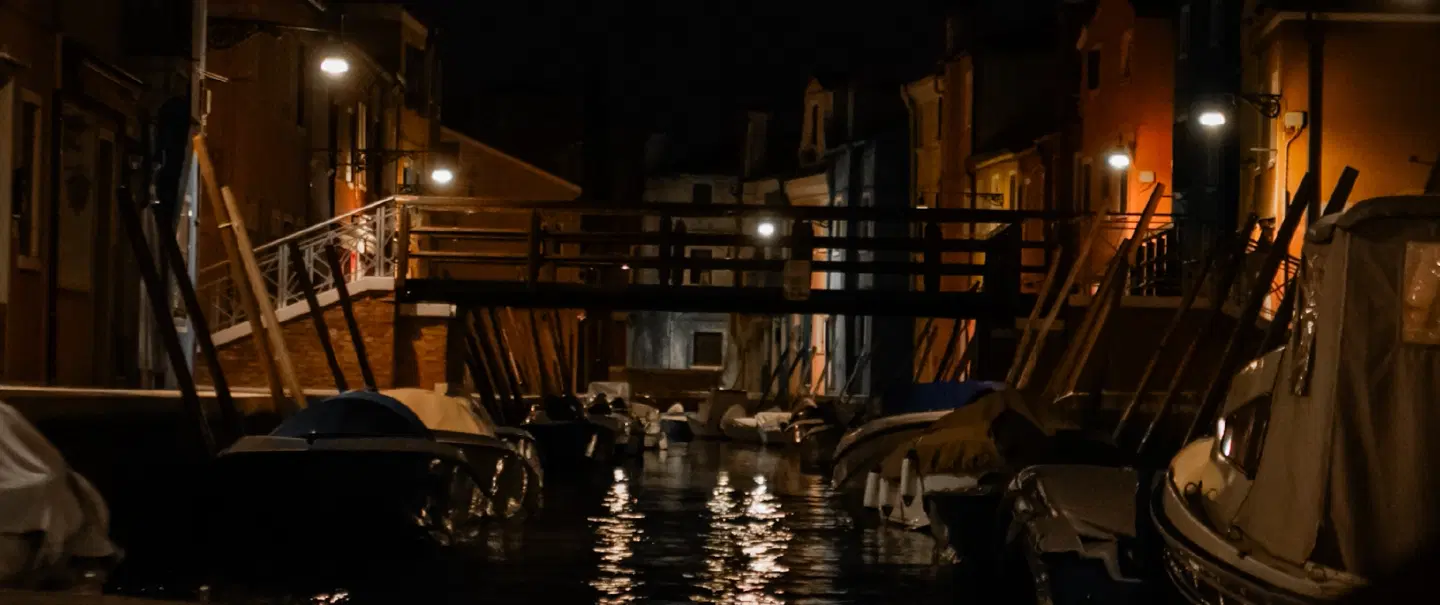 Night Boat Tour in Chioggia in Venice Lagoon on a historic topa through canals and under bridges.