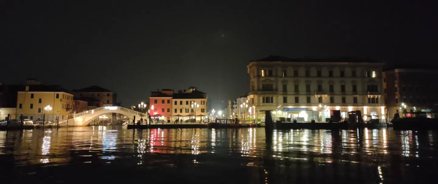 Night Boat Tour in Chioggia in Venice Lagoon on a historic topa through canals and under bridges.