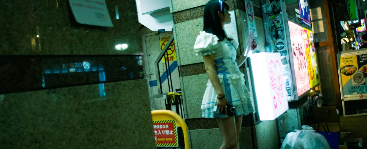 Tokyo night street photography tour in Shinjuku's neon-lit alleys with a documentary photographer.