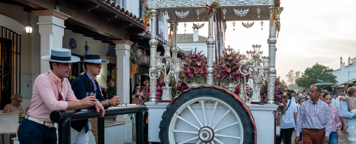 A day inside El Rocío when the village is alive with festival — homes, meals, brotherhoods, song.