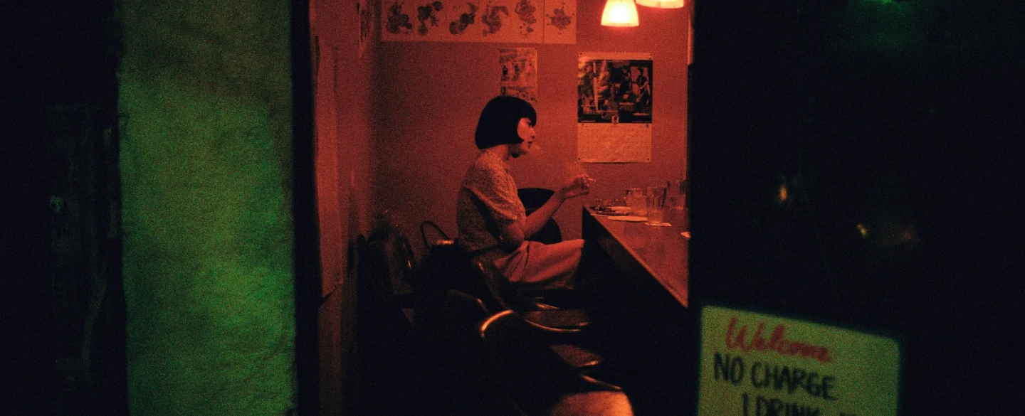 Tokyo night street photography tour in Shinjuku's neon-lit alleys with a documentary photographer.