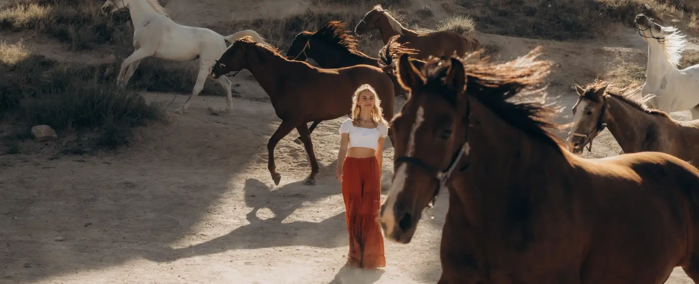Portrait Photoshoot in Cappadocia with wild horses, dramatic landscapes, and expert photographer.