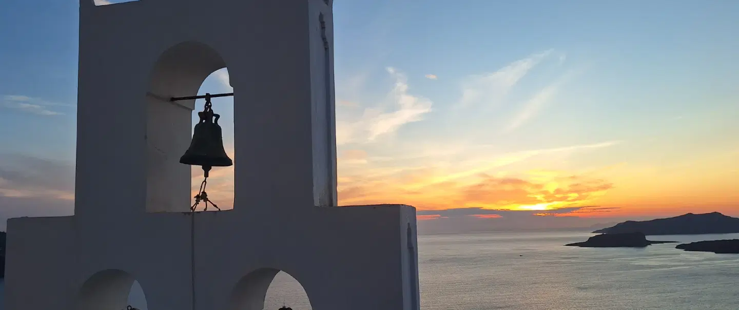 Santorini Vow Renewal on volcanic beach and chapel with photographer, caldera views, and wine.